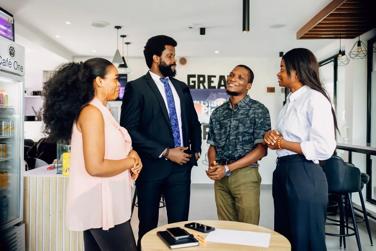 Colleagues greeting each other in a bright office
